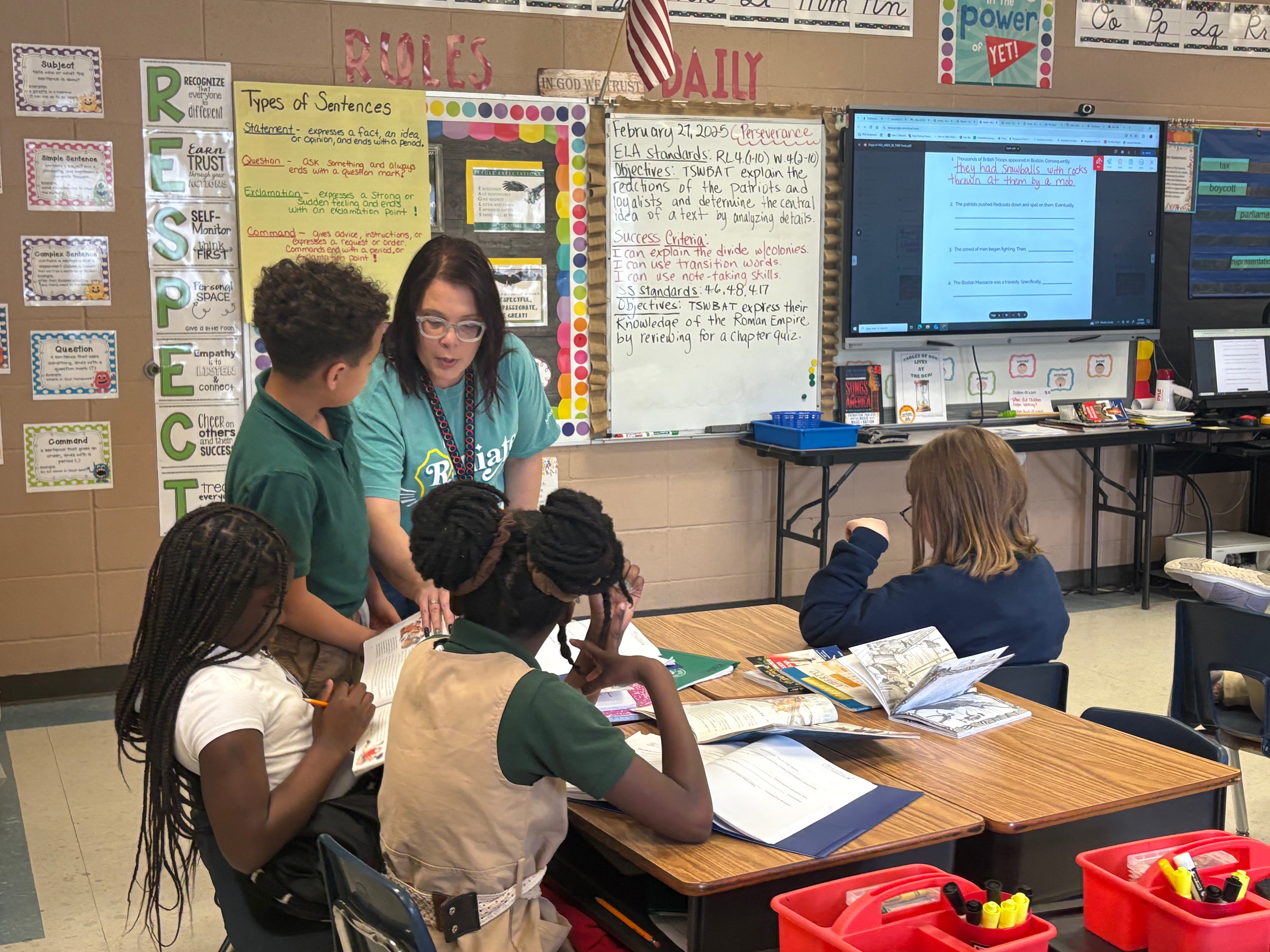 Picture of candidate in a classroom working with students. 