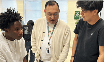 Ivan Gallardo, a Reach Candidate, with two Albertville City learners. 